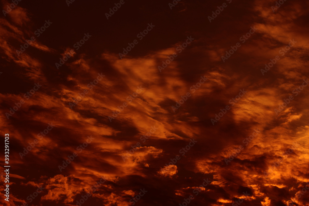 Sky cloudy orange night dramatic beautiful.  Dark sunset beauty bright cloud color idyllic light nature. Outdoors red storm sun sunligh ttime weather. Clouds abstract background.
