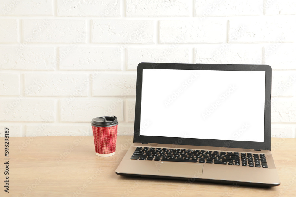 Laptop computer white blank screen with coffee on work table. Front view. Laptop computer white blank screen with coffee on work table. Front view.