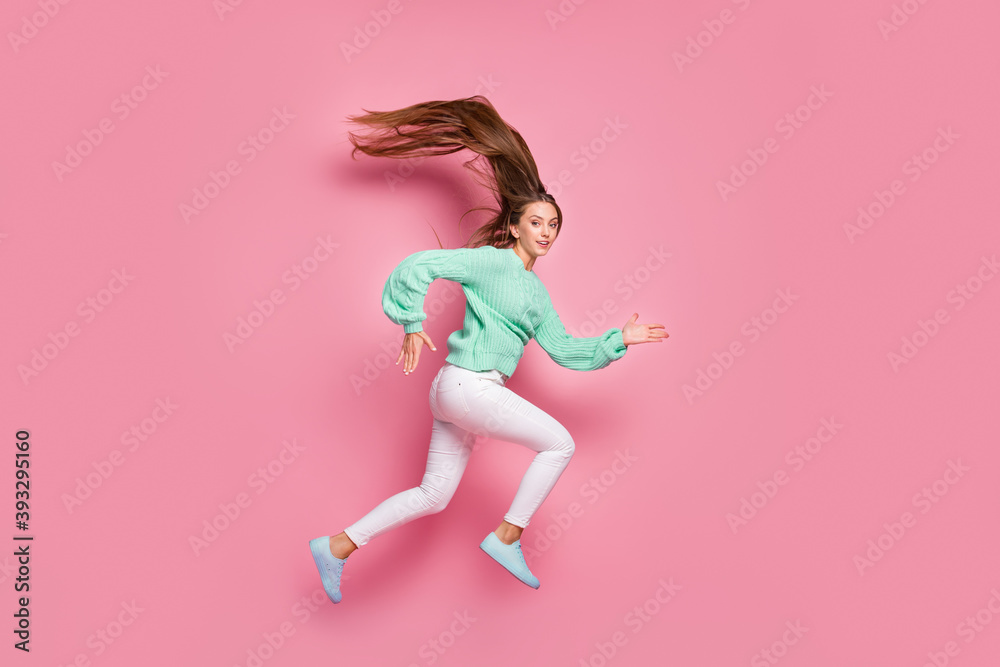 Full size photo of attractive sportive person jump run fast teal sweater isolated on pink color background Full size photo of attractive sportive person jump run fast teal sweater isolated on pink color background