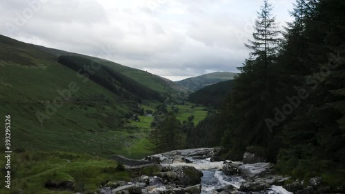 Glenmacnass Waterfall in The Wicklow Mountains, Ireland. Drone is flying forward as the camera tilts down. photo