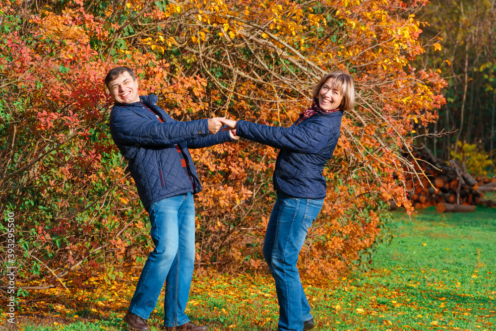 couple walking in autumn city park, happy people together, beautiful nature with colorful leaves couple walking in autumn city park, happy people together, beautiful nature with colorful leaves