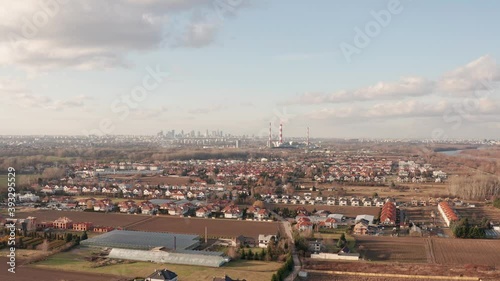 Drone shoot of suburbs in Warsaw, with heat and power plant in the backgroun.