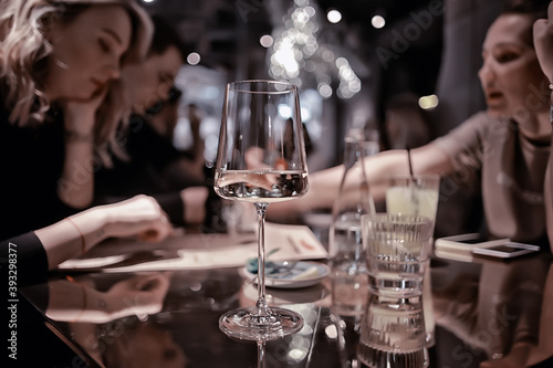 restaurant table view evening wine glass, friends at the party