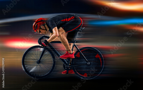 Man racing cyclist on dark background