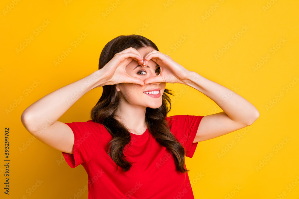Photo of positive girl make fingers heart face look in camera love symbol isolated over bright shine color background Photo of positive girl make fingers heart face look in camera love symbol isolated over bright shine color background