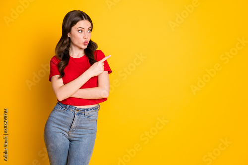 Photo of astonished girl point index finger copyspace lips pouted isolated over bright shine color background