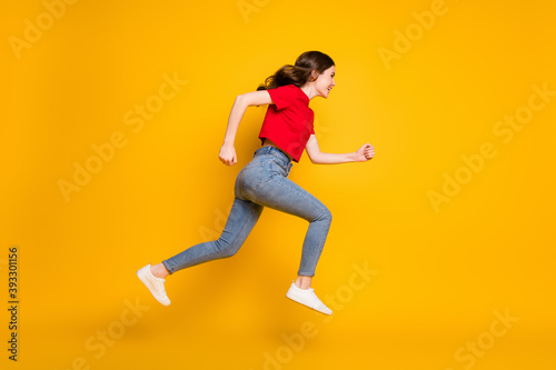 Full body profile side photo of positive cheerful girl jump run discounts wear isolated over shine color background