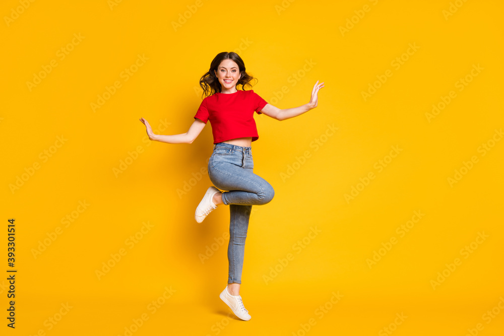 Full size photo of candid girl jump wear red clothes footwear isolated over shine color background