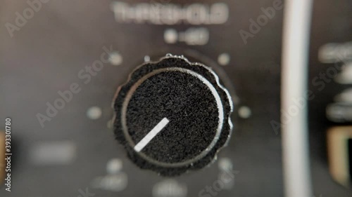 Very close up shot of a rotary knob from an audio processing unit is turned. photo