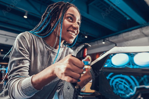 African american girl piloting plane in arcade.