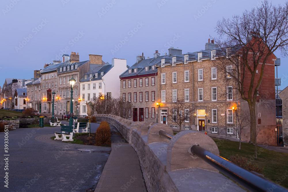 Fototapeta premium Blue hour view of row of mid-19th Century houses on St. Denis Avenue seen from the Pierre-Dugua-de-Mons terrace, Quebec City, Quebec, Canada