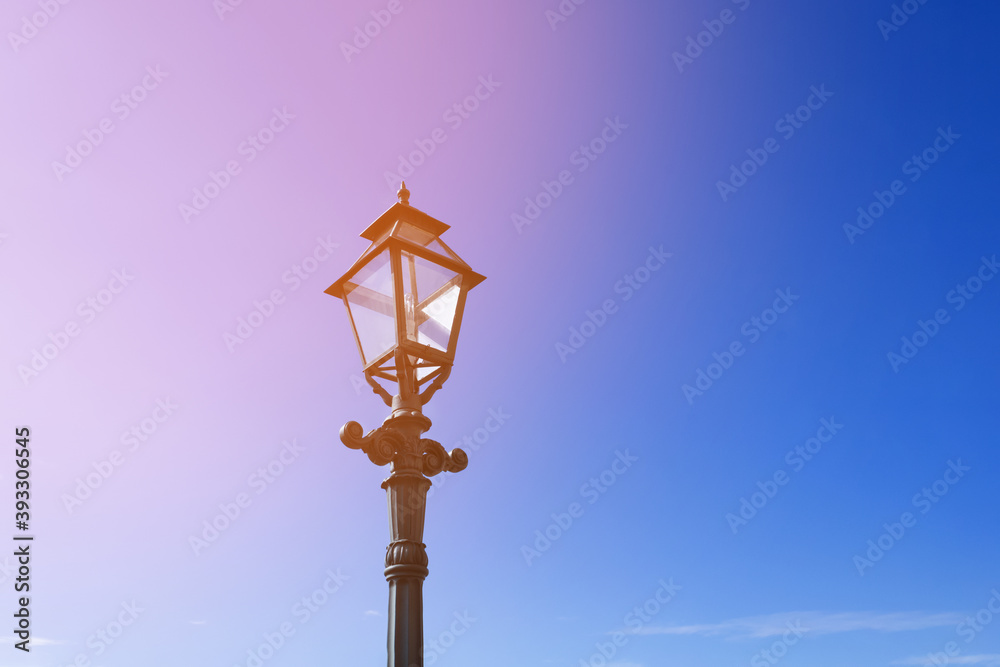 Retro street lamp on clear blue sky background. Tinted.