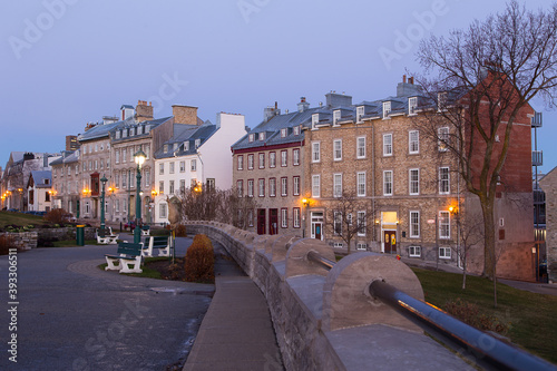 Blue hour view of row of mid-19th Century houses on St. Denis Avenue seen from the Pierre-Dugua-de-Mons terrace, Quebec City, Quebec, Canada