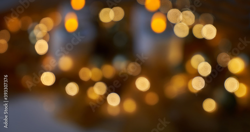 blurry background of shiny golden christmas lights against dark background - can also be used for diwali