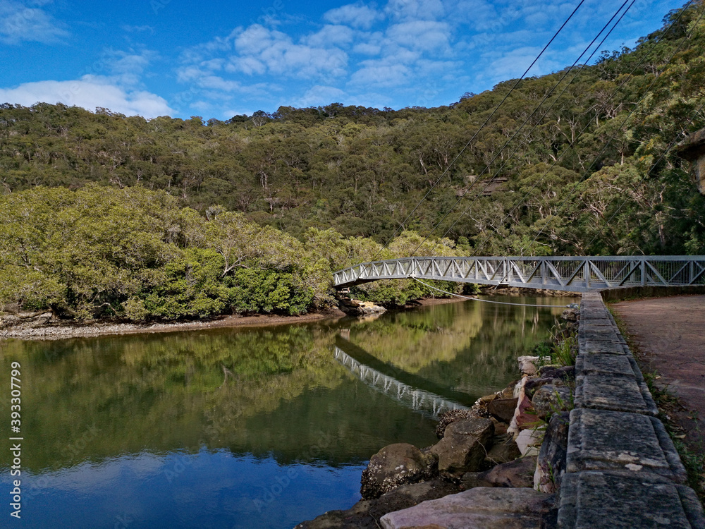 Beautiful panoramic view of a river with reflections of mountains, trees, blue sky and suspension foot bridge, Bobbin Head, Ku-ring-gai Chase National park, Sydney, New South Wales, Australia
Beautiful panoramic view of a river with reflections of mountains, trees, blue sky and suspension foot bridge, Bobbin Head, Ku-ring-gai Chase National park, Sydney, New South Wales, Australia