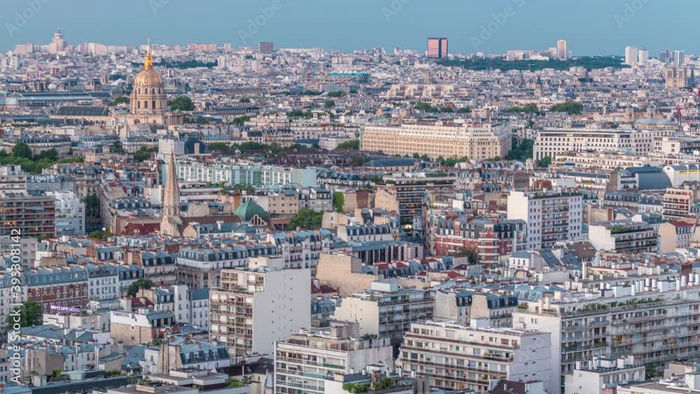 Aerial panorama above houses rooftops in a Paris day to night transition timelapse. Evening view with les invalides and other sightseeings illuminated after sunset Aerial panorama above houses rooftops in a Paris day to night transition timelapse. Evening view with les invalides and other sightseeings illuminated after sunset