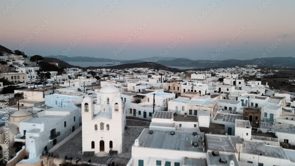 Aerial establishing shot revealing Plaka town in Milos island just before sunrise Aerial establishing shot revealing Plaka town in Milos island just before sunrise