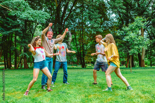 young happy friends at holi fest