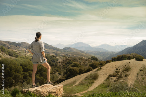 Young woman looking forward to reach the Sierra Nevada Mountain peak in southern Spain