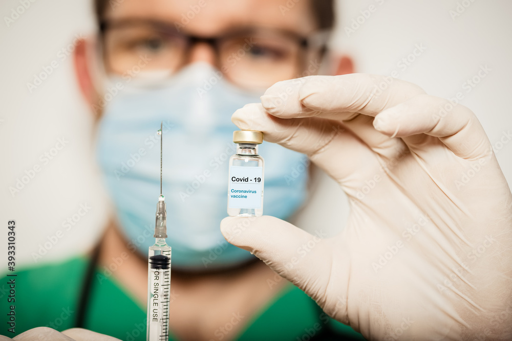 doctor holding covid - 19 coronavirus vaccine doctor holding covid - 19 coronavirus vaccine