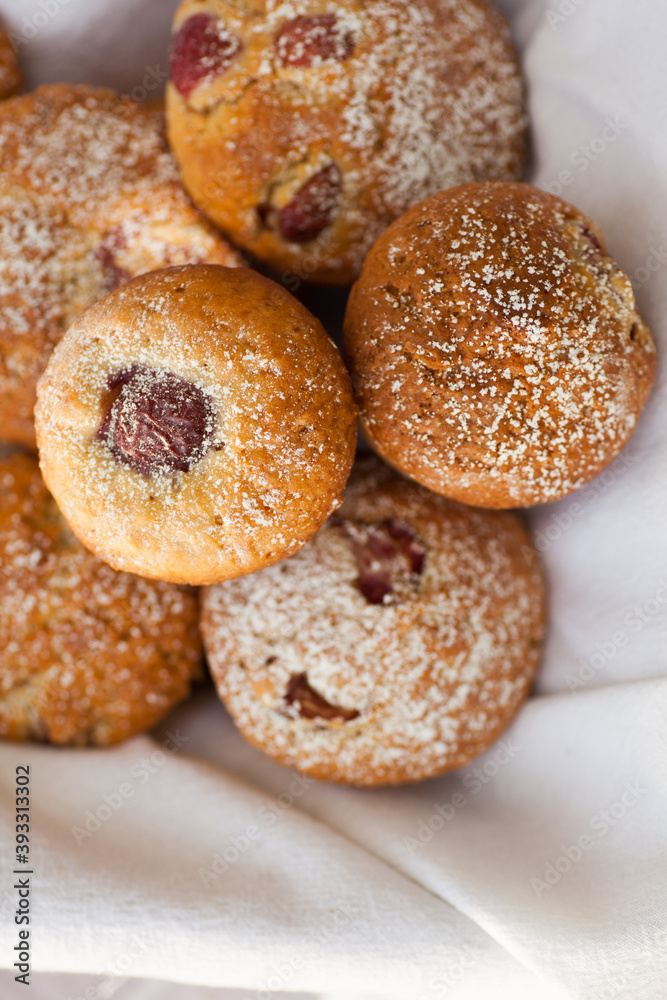 Outdoor studio photo of fresh muffins, bright background. Shallow depth of field, selective focus.