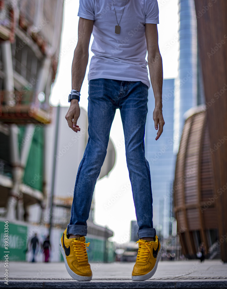 Boy wearing Nike Air Force One LV '07 Yellow on the street Stock Photo