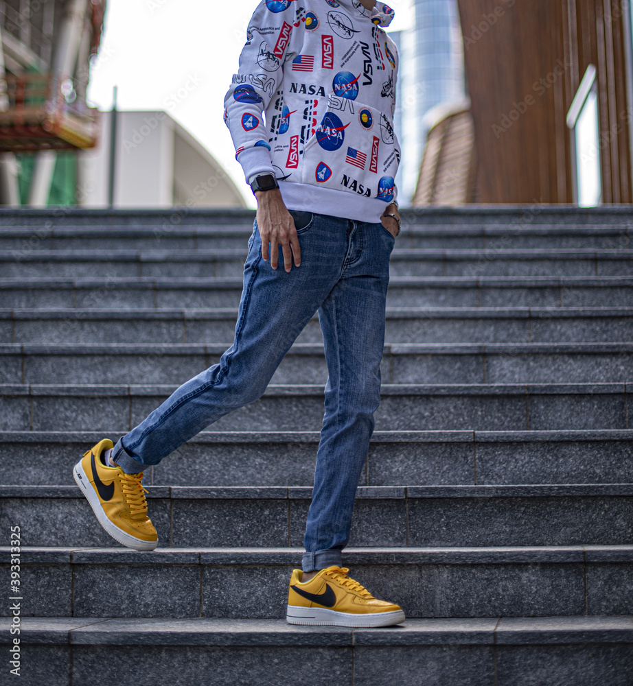 Foto Stock Boy wearing Nike Air Force One LV '07 Yellow on the street |  Adobe Stock