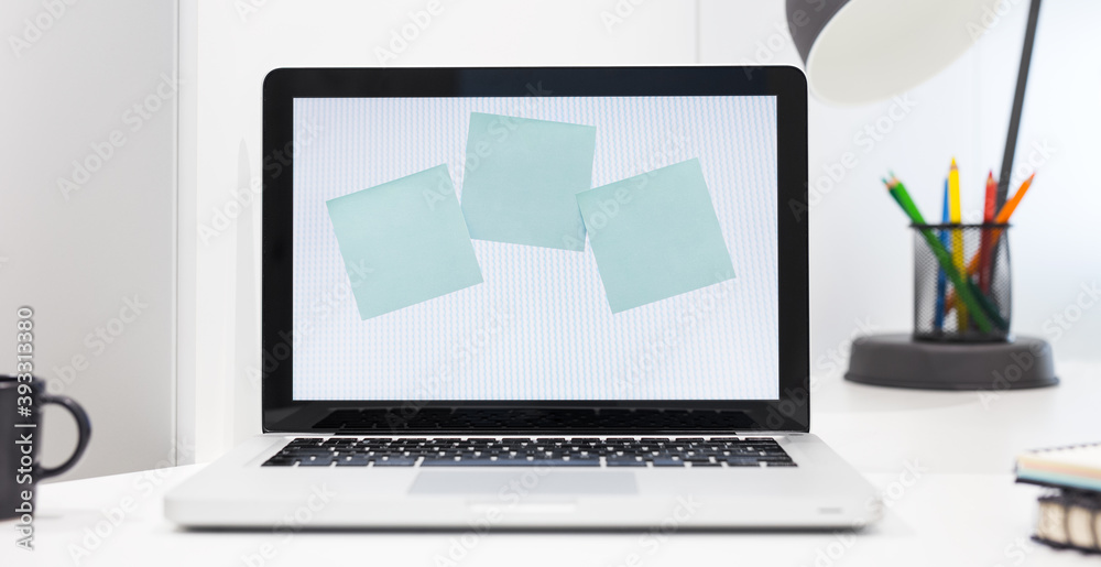 Fototapeta premium Notes sticked to laptop screen at home office.