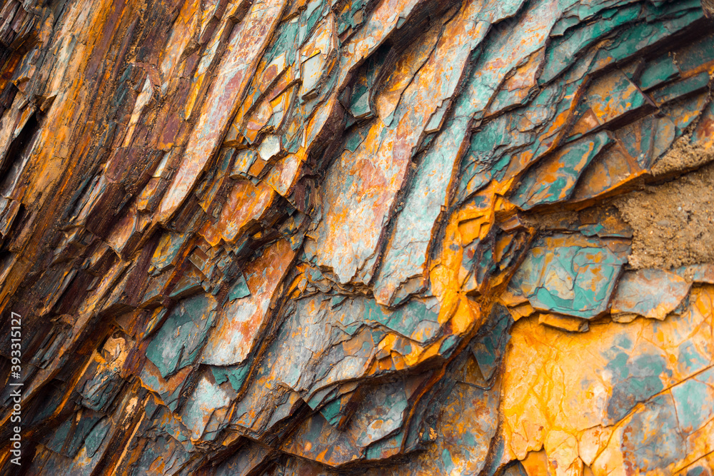 Rock layers , a colorful formation of rocks stacked over time. Interesting background a fascinating texture - obrazy, fototapety, plakaty 