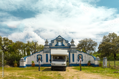Caravan and its owners, in front of a portugheze gate