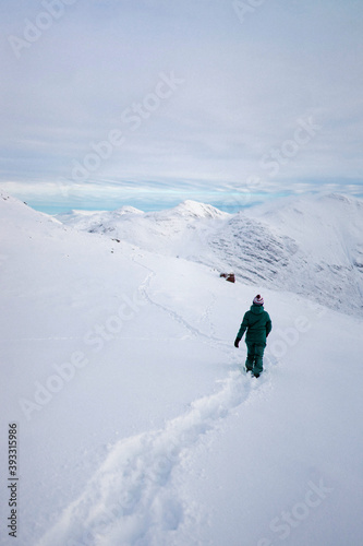 Woman trekking on a snowy mountain