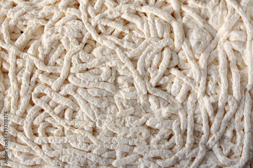 Background white mounting foam. Horizontal photo. Texture of polyurethane foam for wall insulation.Construction foam background. 