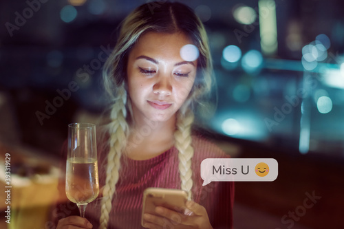 Young woman texting at dinner