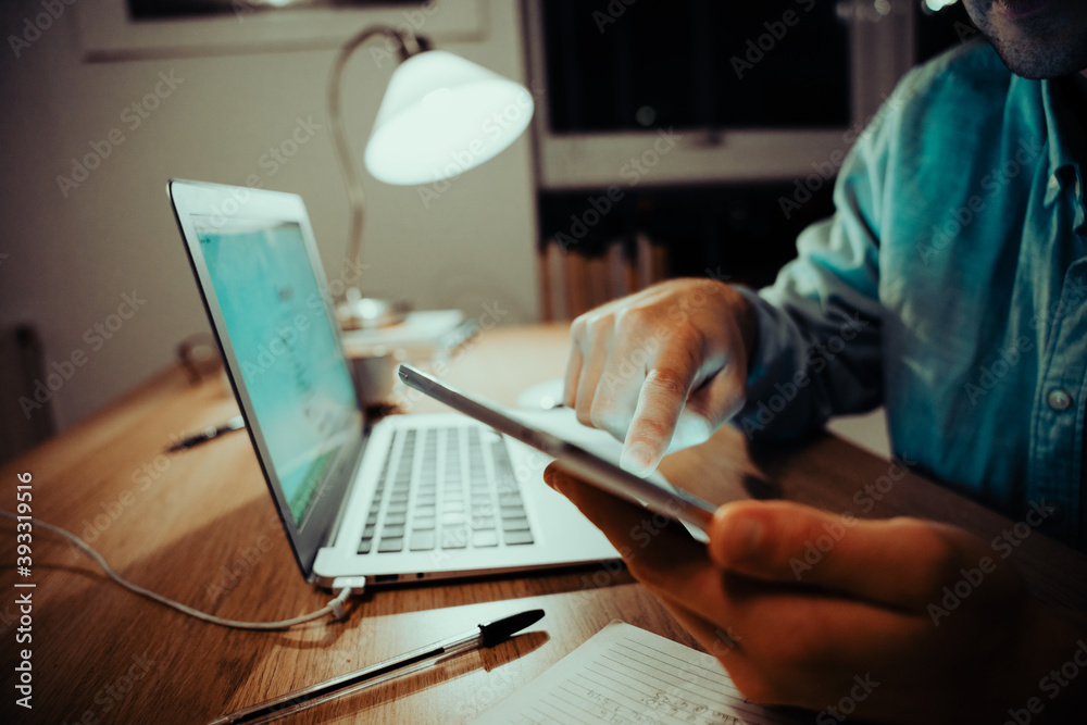 Close up of young caucasian business man typing on cellphone taking a break while working late at night Close up of young caucasian business man typing on cellphone taking a break while working late at night