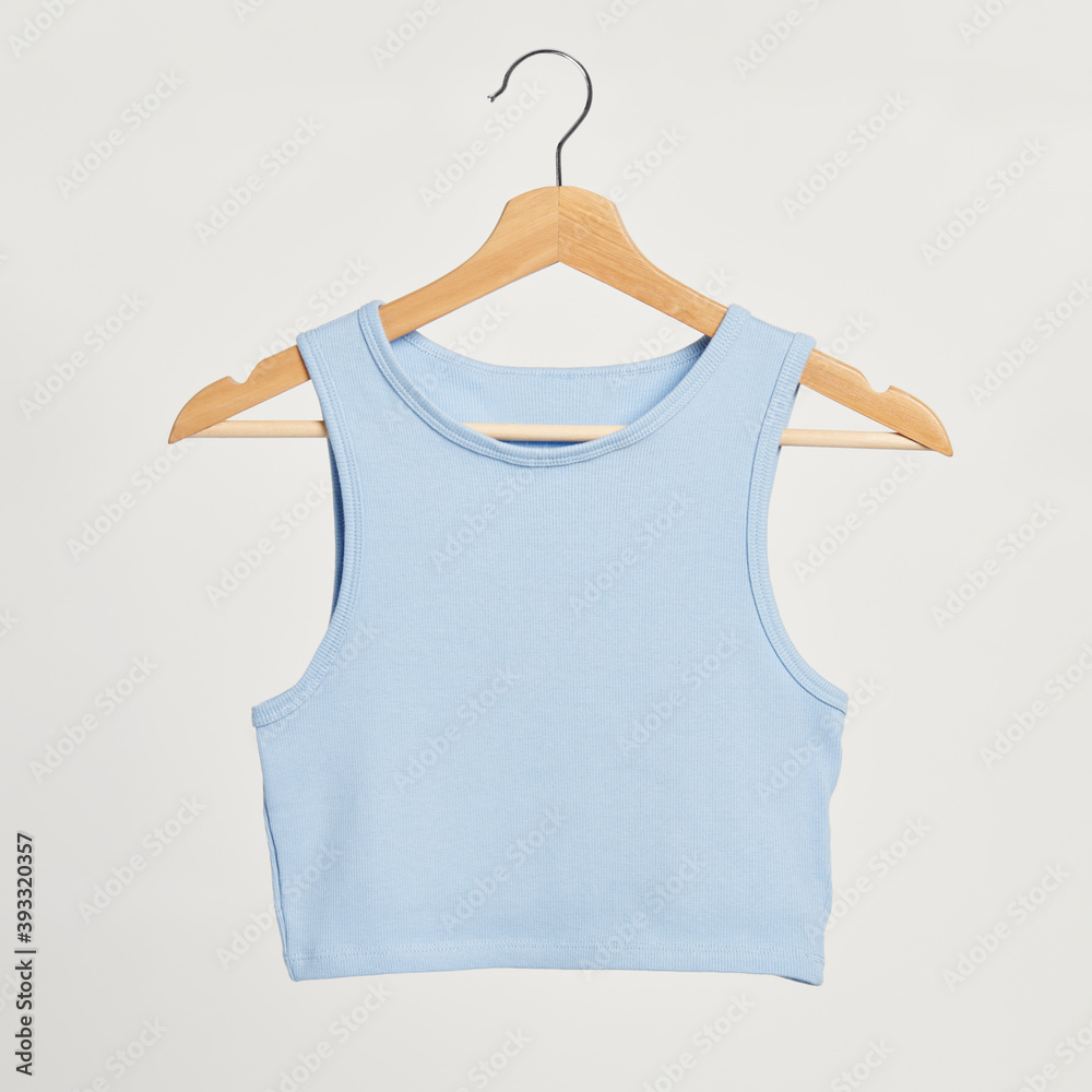 Baby blue cropped top on a wooden hanger Baby blue cropped top on a wooden hanger