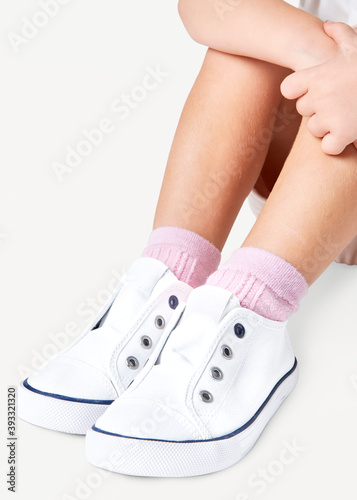 Girl with white sneakers studio shot