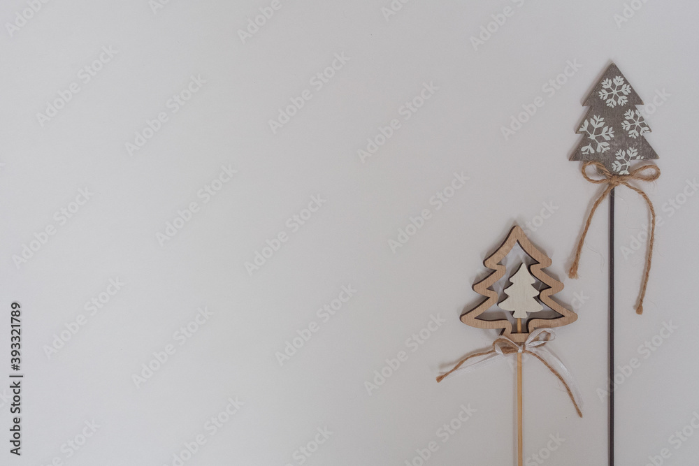 Decorative wooden Christmas trees on a stick on a white background. Christmas decorations with place for text, top view