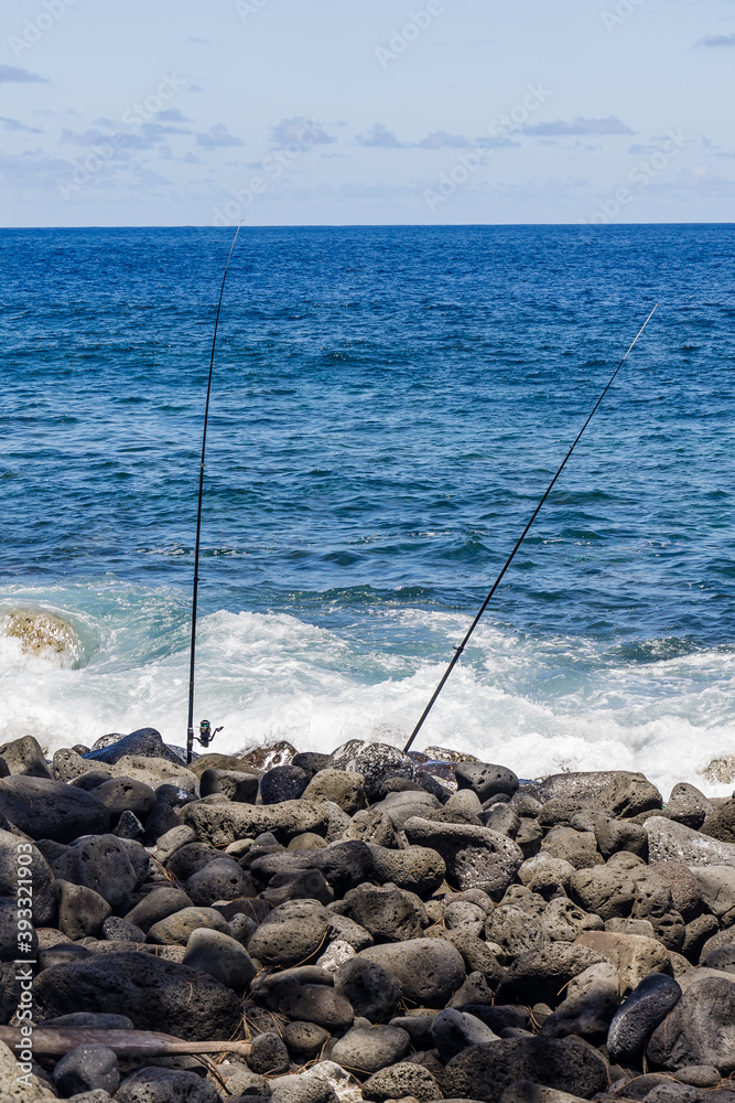 Two fishing rods in Anse des Cascades bay in Sainte-Rose on Reunion Island