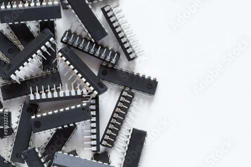 Lots of microcircuits or chips on a white background with copy space. Electronic components