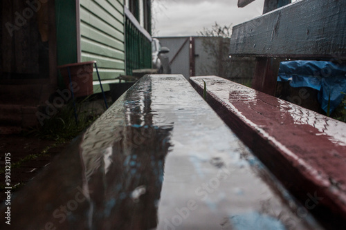 Reflection in water on a wooden bench in the sky