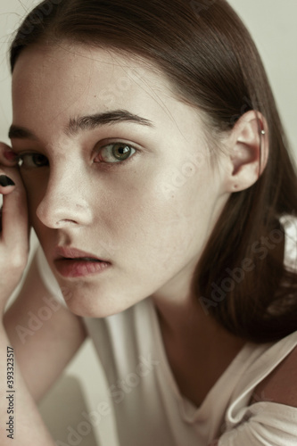  portrait of a woman. modeltest. woman touching perfect smooth face skin, looking at camera