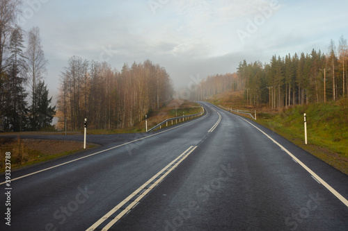 Highway without cars. fog in the distance. Autumn day. in Finland .