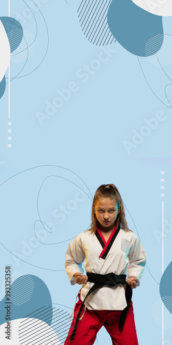 Karate, taekwondo girl with black belt isolated on blue background with geometric design, vertical flyer with copyspace. Little kid training in motion and action. Sport, movement, childhood concept.