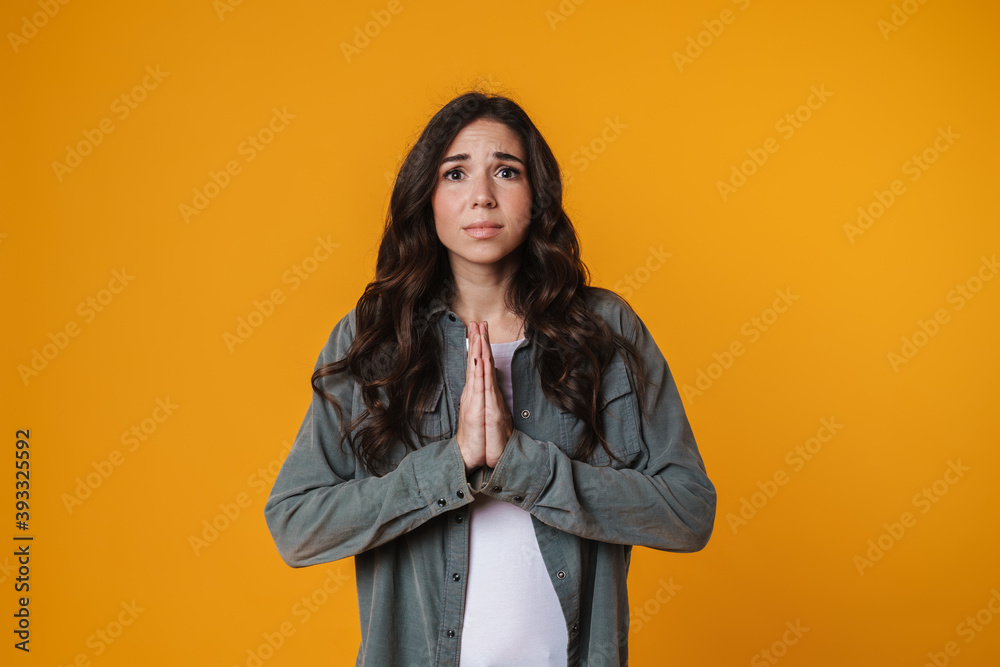 Unhappy beautiful girl posing with palms together Unhappy beautiful girl posing with palms together