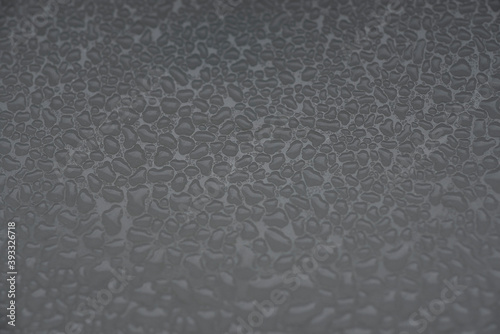 rough grainy textured background with shades of gray as a liquid on a metal surface in black and white backdrop