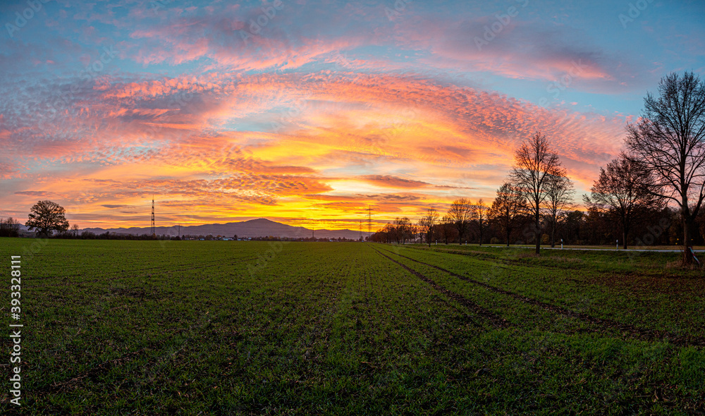 Image of a colorful and high-contrast sunrise with bright cloud formations taken in Germany i