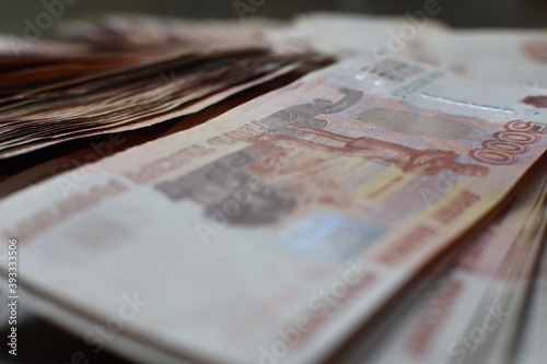 Five thousand dollar bills background. The concept of a Bank loan. Interest to the Bank.