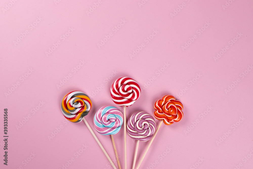 colourful lollipops on the pink background colourful lollipops on the pink background