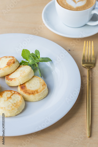 Sweet Cottage cheese pancakes on plate. Russian syrniki, ricotta fritters or curd fritters.