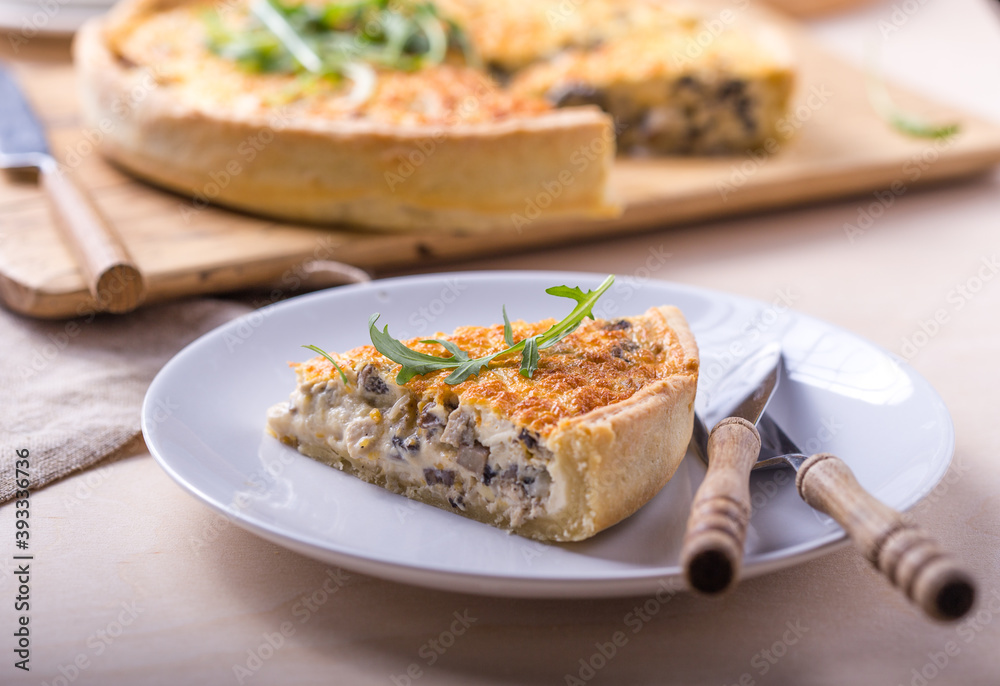 Traditional French Quiche with cheese, spinach and chicken. Quiche lorraine. French cuisine. Top view. Light wooden background